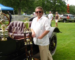 DSC06037 1912 Speedwell Speed Car and Dick Shappy with "Best Of The World" trophy at the Autos Of The World show, Goddard State Park in Warwick, Rhode Island on July...