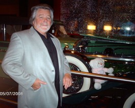 car show 027 Dick posing with his 1934 Duesenberg J-505 Convertible Sedan, Body by Derham, Mohegan Sun Casino, Ledyard, Connecticut, July 4-5 2009.